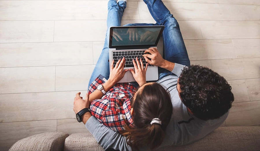 couple on floor laptop